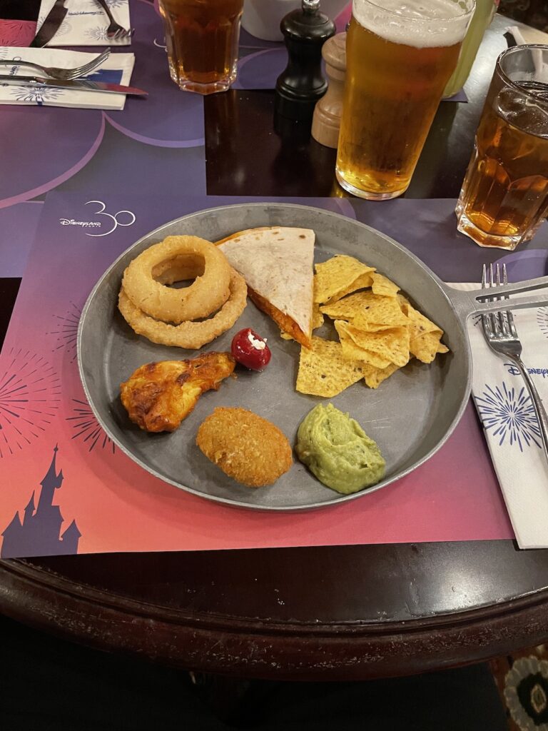 cowboy platter. This consisted of pulled pork quesadillas, chicken wing, cheese-stuffed jalapenos, onion rings, goat’s cheese stuffed peppers, guacamole and Doritos.